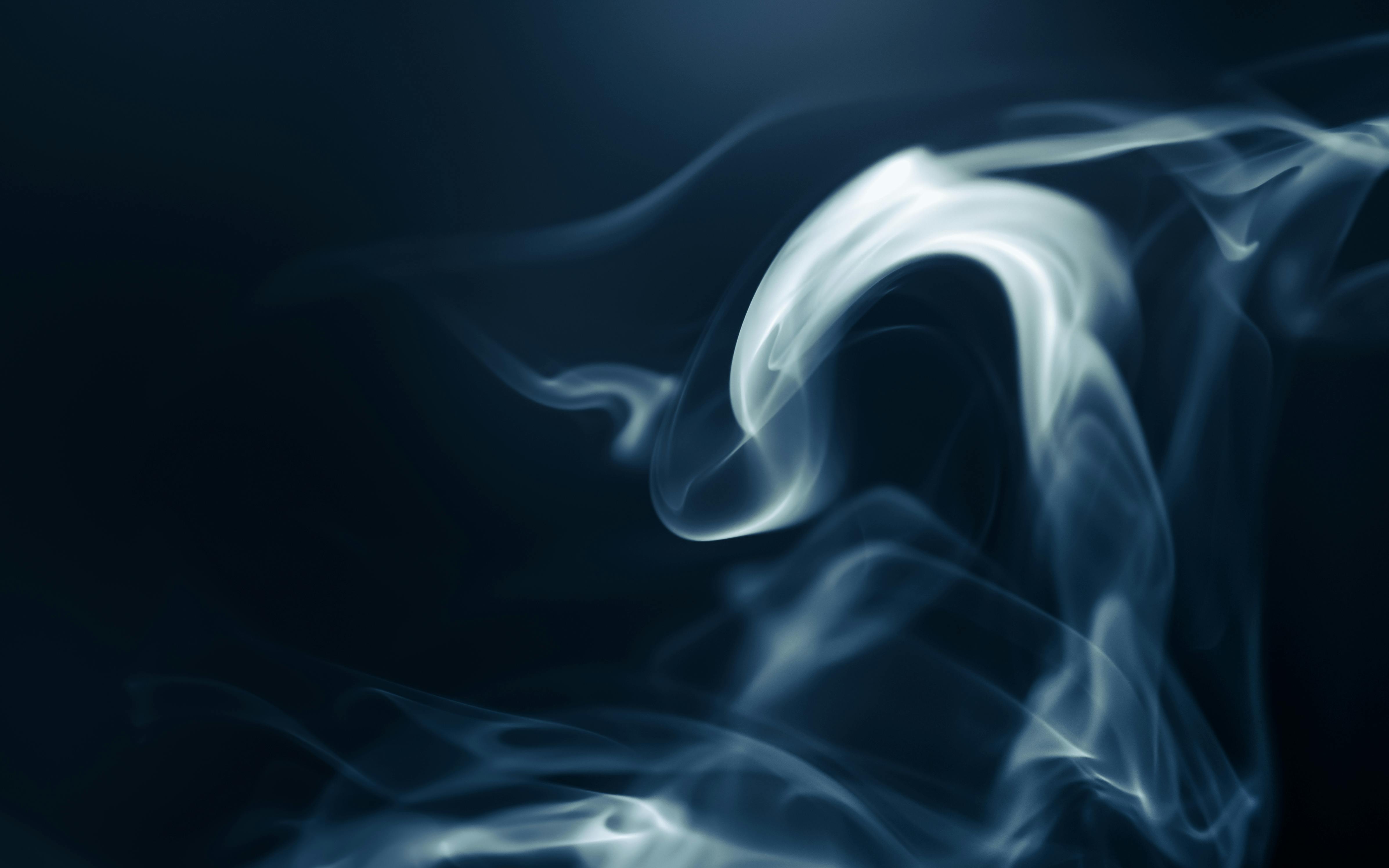 white smoke rising against a black background